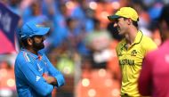 Australia's captain Pat Cummins (R) speaks with his Indian counterpart Rohit Sharma during the toss before the start of the 2023 ICC Men's Cricket World Cup one-day international (ODI) final match between India and Australia at the Narendra Modi Stadium in Ahmedabad on November 19, 2023. Photo by Punit PARANJPE / AFP