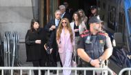 Colombian singer Shakira (C) leaves the High Court of Justice of Catalonia after attending her trial on tax fraud, in Barcelona on November 20, 2023. (Photo by Josep Lago / AFP)