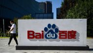 An employee walks past the company logo at Baidu's headquarters in Beijing on September 6, 2022. Photo by Jade GAO / AFP
