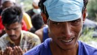Rohingya refugees offer congregational prayers at a temporary shelter in Lapang Barat village, Bireuen, Aceh province on November 21, 2023. (Photo by Zikri Maulana and Zikri MAULANA / AFP)
