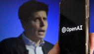 This illustration photo produced in Arlington, Virginia on November 20, 2023, shows a smartphone screen displaying the logo of OpenAI juxtaposed with a screen showing a photo of former OpenAI CEO Sam Altman attending the Asia-Pacific Economic Cooperation (APEC) Leaders' Week in San Francisco, California, on November 16, 2023. Photo by OLIVIER DOULIERY / AFP