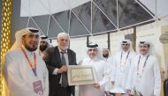 Minister of Municipality H E Dr. Abdullah bin Abdulaziz bin Turki Al Subaie is presented a plaque bearing his name by a calligrapher during the opening of the pavilion of the Ministry of Awqaf and Islamic Affairs at the Expo 2023 Doha yesterday.