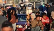 Palestinians who had taken refuge in temporary shelters return to their homes in eastern Khan Yunis in the southern Gaza Strip during the first hours of the four-day truce on November 24, 2023. Photo by MAHMUD HAMS / AFP