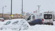 File photo: An ambulance passes an abandon car during a winter storm that hit the Buffalo region, in Amherst, New York, US, on December 26, 2022. (Reuters)