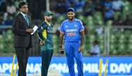 India's captain Suryakumar Yadav (R) and as his Australia's counterpart Matthew Wade (C) looks on during the toss before the start of the second Twenty20 international cricket match between India and Australia at the Greenfield International Stadium in Thiruvananthapuram on November 26, 2023. (Photo by R.Satish BABU / AFP).