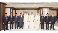President of the Supreme Judiciary Council and President of the Court of Cassation H E Dr. Hassan bin Lahdan Al Mohannadi (fifth left), Chief Justice of the Supreme Court of Indonesia H E Muhammad Syarifuddin (fourth left), and other officials pose for a group picture in Doha yesterday.
