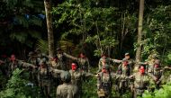 File photo: Guerrillas of the New People's Army (NPA) are seen in formation in the Sierra Madre mountain range, east of Manila, on July 30, 2017. (Photo by Noel Celis / AFP)