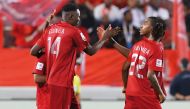 Al Duhail's Michael Olunga (left) celebrates with teammates on Monday.