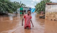 A Somali boy moves through floodwaters in Dolow on November 25, 2023. Photo by Hassan Ali Elmi / AFP