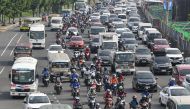 Motorists and vehicles travel along a road amid traffic jam in Manila on November 24, 2023. (Photo by Ted ALJIBE / AFP)
