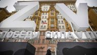 A woman walks past huge Z and V letters - tactical insignias of Russian troops in Ukraine, placed in front of the US Embassy in central Moscow on November 30, 2023. (Photo by Alexander Nemenov / AFP)