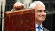 (FILES) Britain's Finance Minister Alistair Darling poses for pictures with a briefcase containing the 2010 Budget Report at a photocall outside 11 Downing Street in London, on March 24, 2010. (Photo by Ben STANSALL / AFP)
