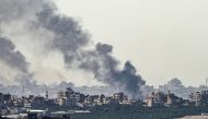 Smoke rising from buildings after being hit by Israeli strikes on December 2, 2023. (Photo by John MacDougall / AFP)