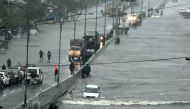 Commuters make their way through a flooded road after heavy rains in Chennai on December 4, 2023. (All photos by R Satish Babu/ AFP)
