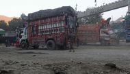 Trucks are pictured at the zero point Torkham border crossing between Afghanistan and Pakistan, in Nangarhar province on December 6, 2023. (Photo by Shafiullah Kakar / AFP)