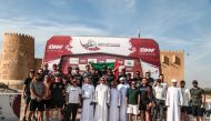 Participants and officials pose for a group photo after the final round of Qatar Off Road Championship. 
