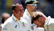Australia's David Warner (R) and teammate Usman Khawaja leave at the lunch break during the first day of the first Test cricket match against Pakistan on December 14, 2023. (Photo by Colin Murty / AFP) 