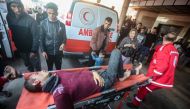 Palestinians react as the injured are brought to Nasser hospital in Khan Yunis in the southern Gaza Strip following Israeli bombardment on December 15, 2023. Photo by AFP