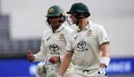 Australia's Usman Khawaja (L) and teammate Steve Smith walk off at close of play on day three in Perth on December 16, 2023. (Photo by Colin Murty / AFP) 