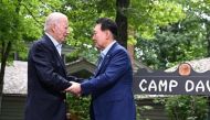 US President Joe Biden (left) welcomes South Korean President Yoon Suk Yeol (right) to Camp David, Maryland, for a Trilateral Summit on August 18, 2023. (Photo by Jim Watson / AFP)

