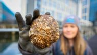 Marine Conservation officer with Ulster Wildlife Rachel Millar, holds an oyster at the City Quays, in Belfast, Northern Ireland, on November 28, 2023. Photo by PAUL FAITH / AFP