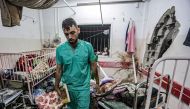 A man inspects the damage in a room following Israeli bombardment at Nasser hospital in Khan Yunis in the southern Gaza Strip on December 17, 2023. Photo by STRINGER / AFP