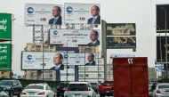 (FILES) Motorists drive past campaign billboards of Egypt's President Abdel Fattah al-Sisi along a street in Cairo on December 7, 2023, ahead of the country's presidential election. (Photo by Khaled DESOUKI / AFP)
