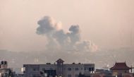 A picture taken from Rafah shows smoke billowing over Khan Yunis in the southern Gaza Strip on December 19, 2023. (Photo by Said Khatib / AFP)