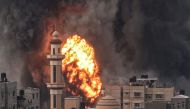 A fireball erupts after Israeli strike over Rafah in the southern Gaza Strip on December 20, 2023. (Photo by Said Khatib / AFP)