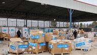 Boxes containing humanitarian aid are unloaded at the Karm Abu Salem (Kerem Shalom) crossing in Rafah in the southern Gaza Strip, on December 21, 2023. (Photo by Mohammed Abed / AFP)