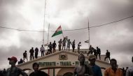 File: Protesters hold a Niger flag during a demonstration on independence day in Niamey on August 3, 2023. The demonstrators converged at Concertation Square in the heart of the city, following a call by a coalition of civil society associations on a day marking the country's 1960 independence from France. (Photo by AFP)