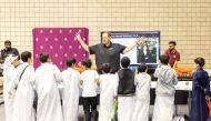 Children see a demonstration about ‘Genome Heroes’ app at the booth of Qatar Precision Health Institute during the National Science Research and Innovation Week 2023.