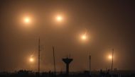 Flares fired by Israeli soldiers over Khan Yunis in the southern Gaza Strip on December 22, 2023. (Photo by Mahmud Hams / AFP)
