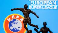 FILE PHOTO: Metal figures of football players are seen in front of the words 