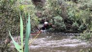 This handout photo taken and released by the Victoria Police on December 27, 2023 shows an emergency worker during a rescue operation in the midst of flood waters after heavy rain at the Buchan campground in east Gippsland, located east of Melbourne in the Australian state of Victoria. Photo by Handout / VICTORIA POLICE / AFP