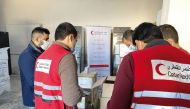 QRCS employees with some of the aid provided for Syria