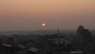 Sun rises above Rafah in the southern Gaza Strip on January 1, 2024. (Photo by AFP)