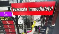 This image taken in Hong Kong on January 1, 2024 shows a warning message on a screen from a live feed on NHK World asking people to evacuate from the area after a series of major earthquakes hit central Japan. (Photo by Mladen Antonov / AFP)