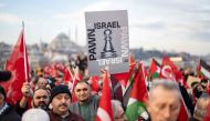 Thousands demonstrate to show solidarity with the Palestinian people at the Galata Bridge in Istanbul on January 1, 2024. (Photo by Yasin Akgul / AFP)