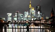 A man with an umbrella crosses the Main river on a rainy day in Frankfurt am Main, western Germany, on January 2, 2024. (Photo by Kirill KUDRYAVTSEV / AFP)
