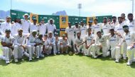 South Africa (L) and India (R) players pose with the trophy after drawing the series at Newlands stadium in Cape Town on January 4, 2024. (Photo by Rodger Bosch / AFP)
