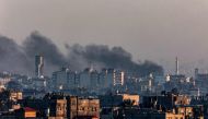 A picture taken from Rafah on January 7, 2024, shows smoke billowing over Khan Yunis in the southern Gaza Strip. (Photo by AFP)