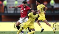 Egypt's forward #10 Mohamed Salah (L) fights for the ball with Mozambique's midfielder #7 Elias Pelembe (C) during the Africa Cup of Nations (CAN) 2024 group B football match between Egypt and Mozambique at the Felix Houphouet-Boigny Stadium in Abidjan on January 14, 2024. (Photo by FRANCK FIFE / AFP)
