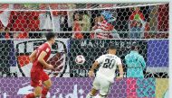 Iraq’s Osama Rashid (right) scores his team’s second goal against Indonesia. AFP
