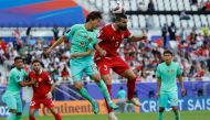 China's midfielder #10 Xie Pengfei fights for the header with Lebanon's defender #03 Maher Sabra during the Qatar 2023 AFC Asian Cup Group A football match between Lebanon and China at the Al-Thumama Stadium in Doha on January 17, 2024. (Photo by KARIM JAAFAR / AFP)
