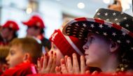 Children listen as Republican presidential candidate, former US President Donald Trump speaks during a campaign rally at the Atkinson Country Club on January 16, 2024 in Atkinson, New Hampshire. (Photo by Brandon Bell / Getty Images via AFP)
