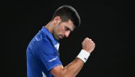 Serbia's Novak Djokovic reacts after a point against Argentina's Tomas Etcheverry during their men's singles match on day six of the Australian Open tennis tournament in Melbourne on January 19, 2024. (Photo by WILLIAM WEST / AFP) 
