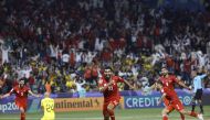 Bahrain’s defender Abdullah Al Khalasi celebrates after teammate Ali Madan (second right) scored a goal against Malaysia. AFP