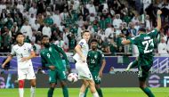 Saudi Arabia’s midfielder Mohamed Kanno (right) shoots to score his team’s first goal against Kyrgyzstan. AFP