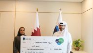Dukhan Bank customer receiving the grand prize.